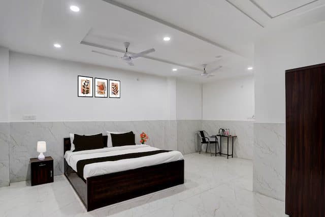 Premium room with a double bed, bedside table and a lounge chair